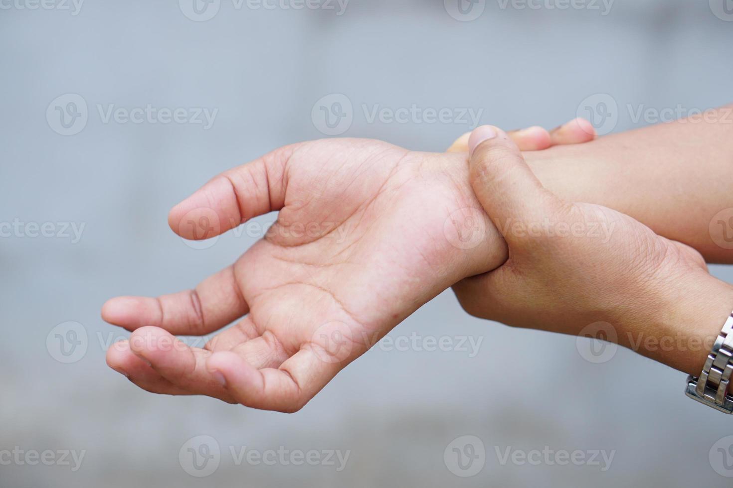 Woman holding her wrist pain from using computer, office syndrome photo