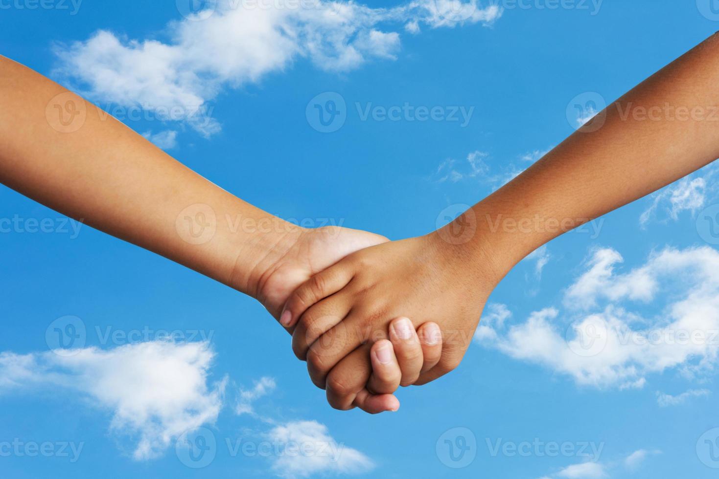 Couple holding hands sky background photo