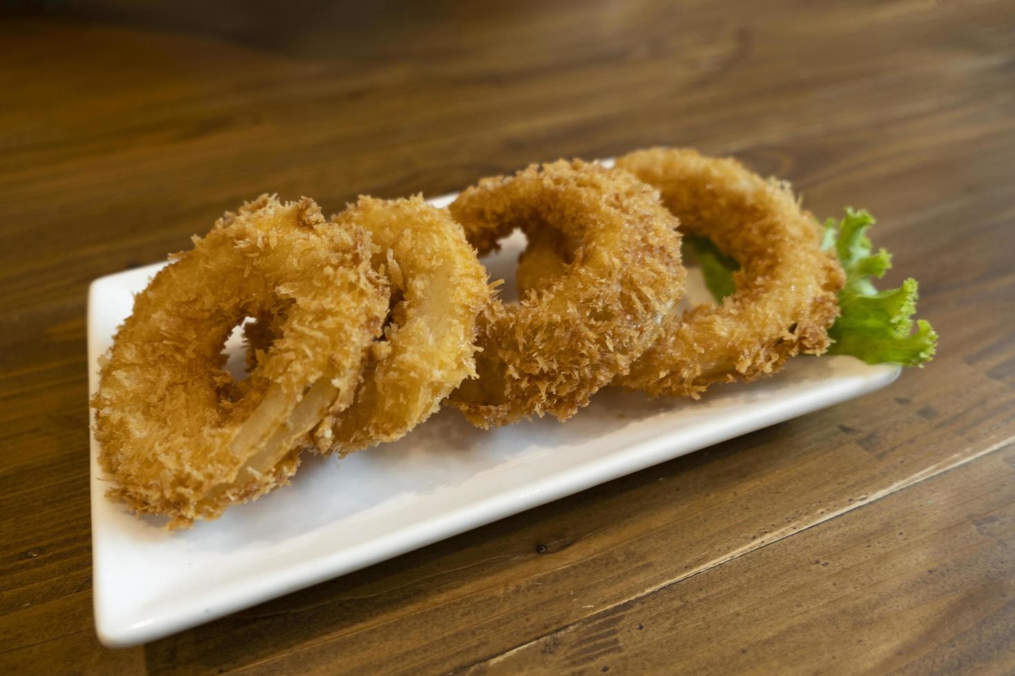 Onions fried on a wooden table photo