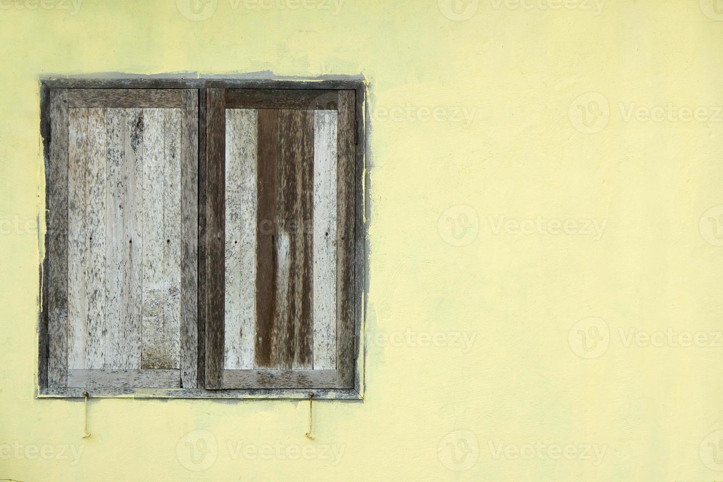 old wooden window on cement wall photo