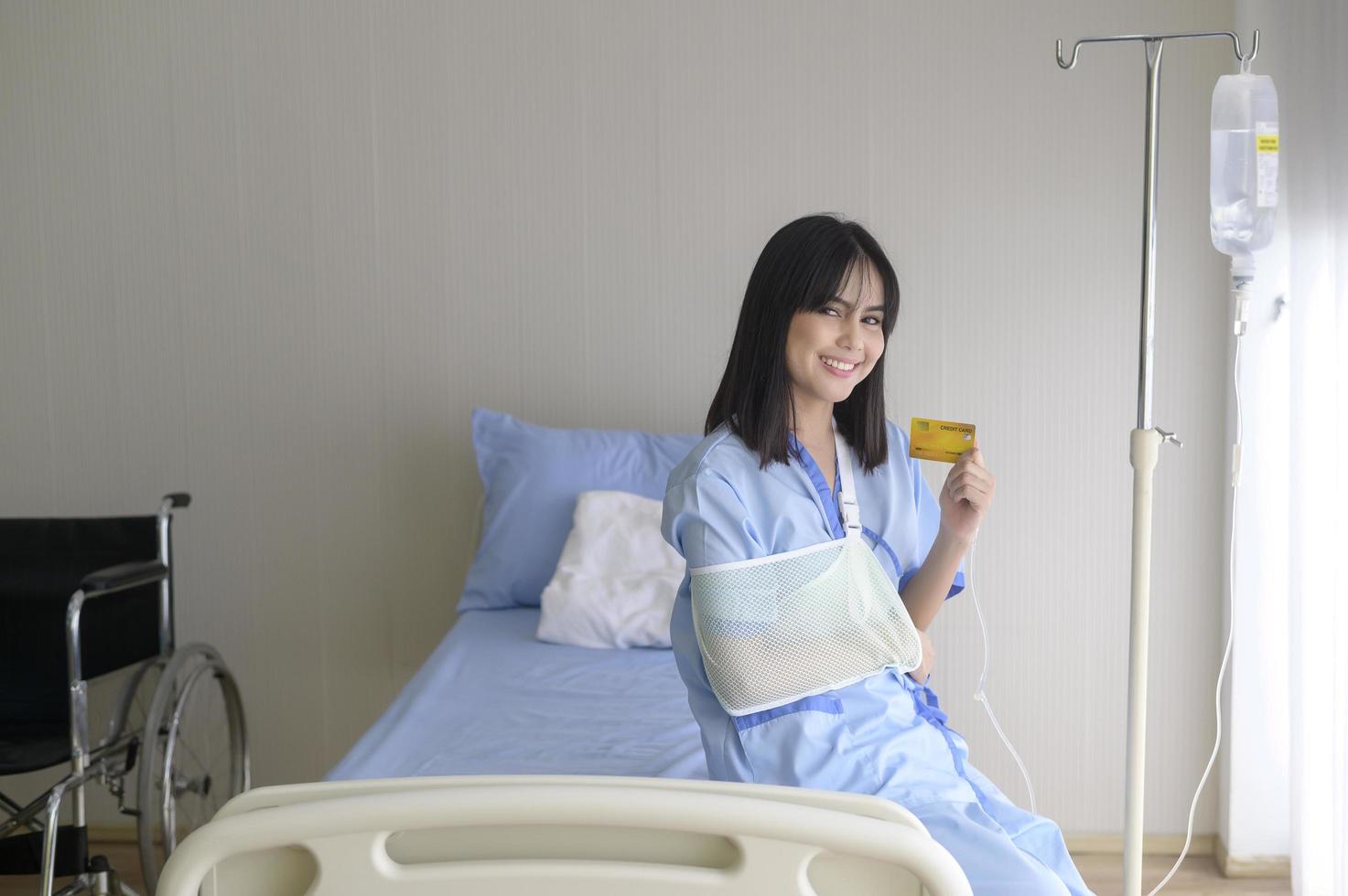 A young patient woman is holding credit card , admitting in hospital , Health care  concept photo