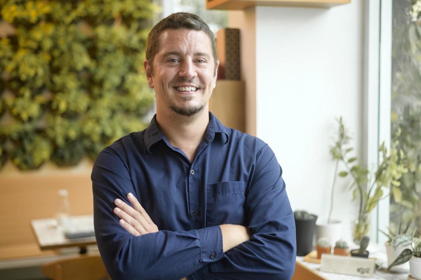 Portrait of business caucasian man in coffee shop photo