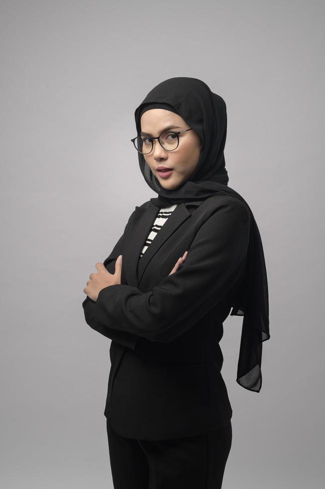 Beautiful muslim woman wearing glasses over white background studio photo