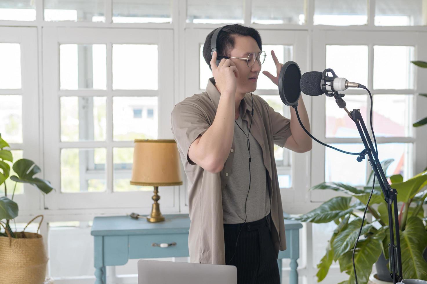 A musician man  is recording new song in home Studio photo