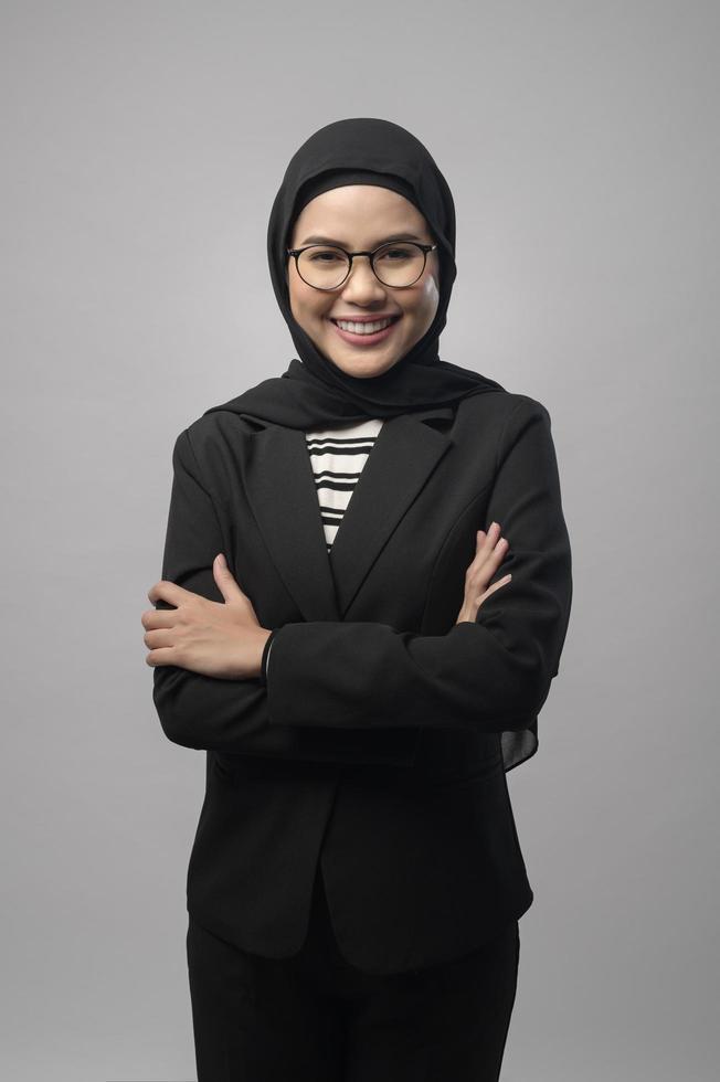 Beautiful muslim woman wearing glasses over white background studio photo