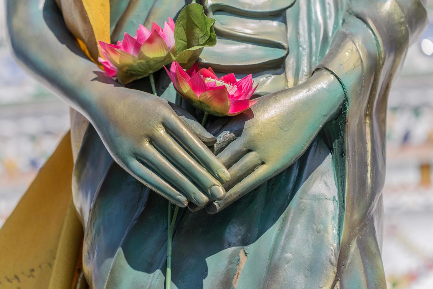 Lotus in hand of buddha photo