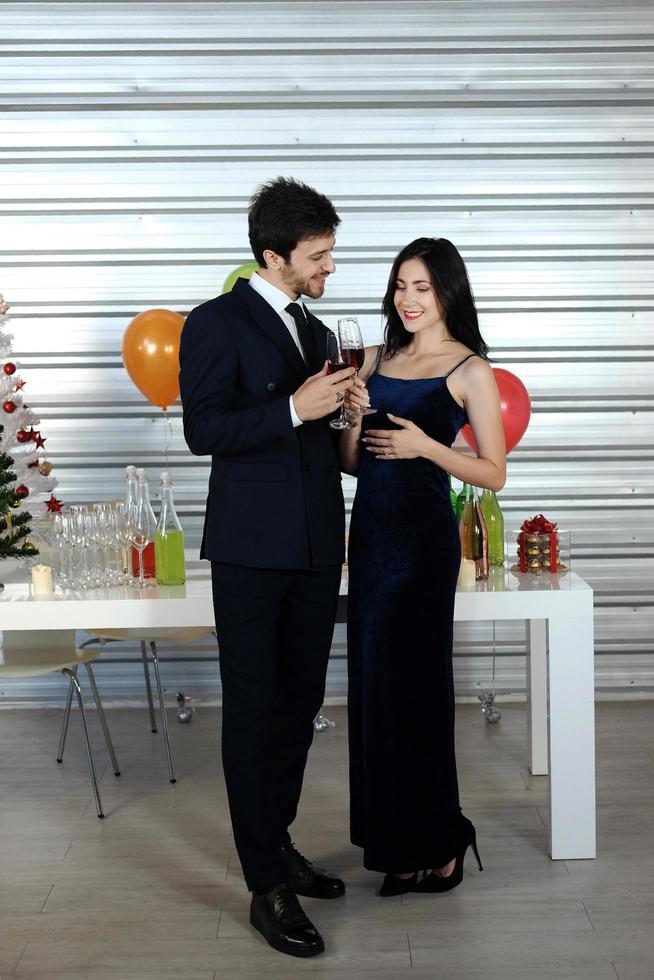 Sweet couple Love smile and spending Romantic with drinking wine in christmas time and celebrating new year eve, valentine day with colorful balloon and Gift Boxes at pantry area photo