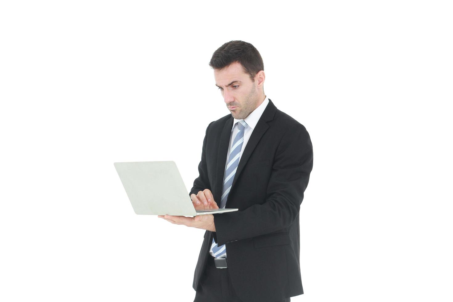 Successful and handsome  businessman in a suit smiling with hand holding notebook. He serious in working on a laptop isolated on white background. Copy space photo