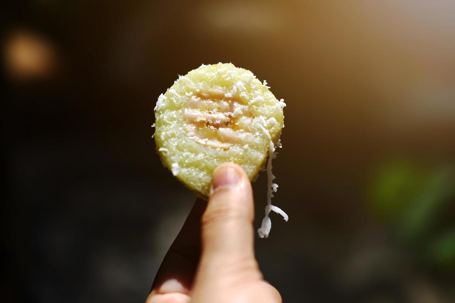 Thai sweet Dessert, Banana in steamed Sticky Rice pieces on white Foam box photo