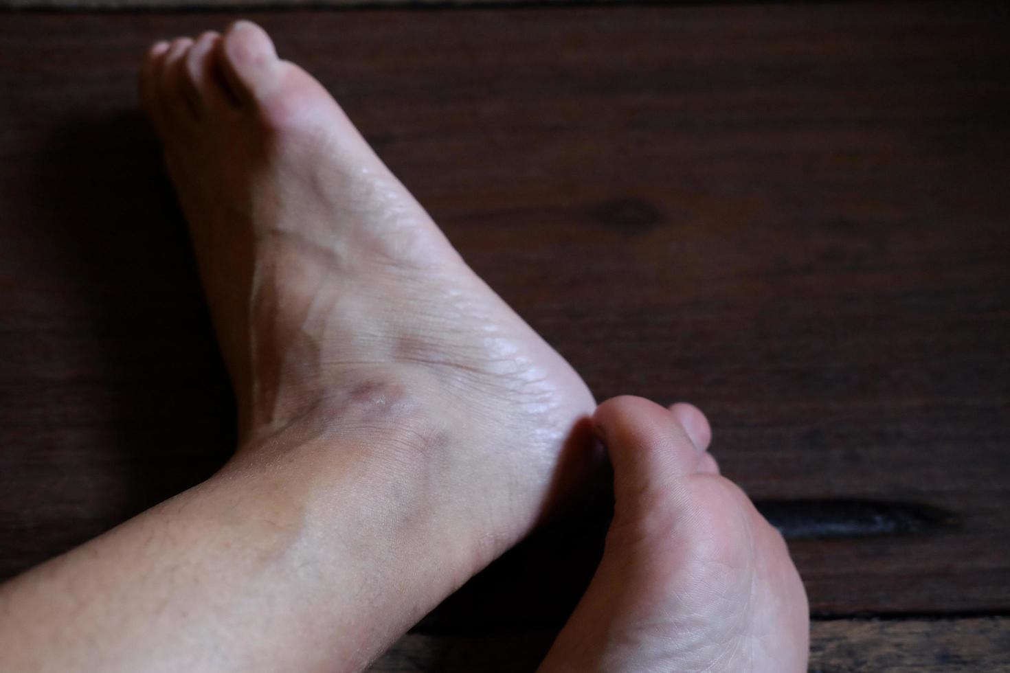 Closed up female feet with french nails on wood floor, Healthy care and medical concept photo