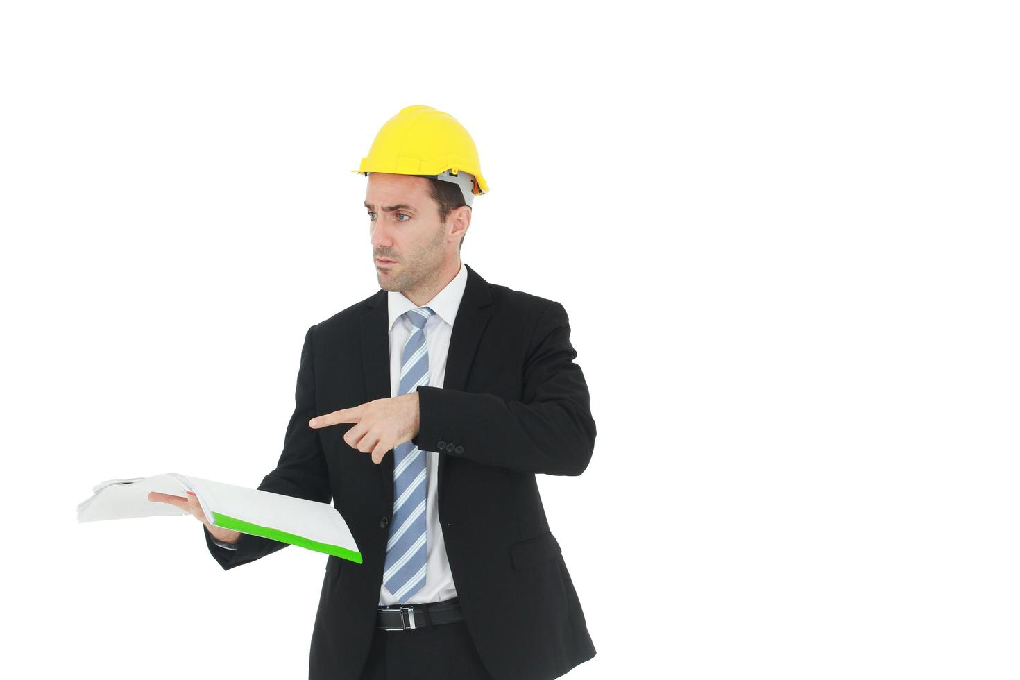 Handsome and smart engineer in black suit Wearing a yellow safety engineering hat with hand holding Construction drawing papers and serious in work isolated on yellow background. photo