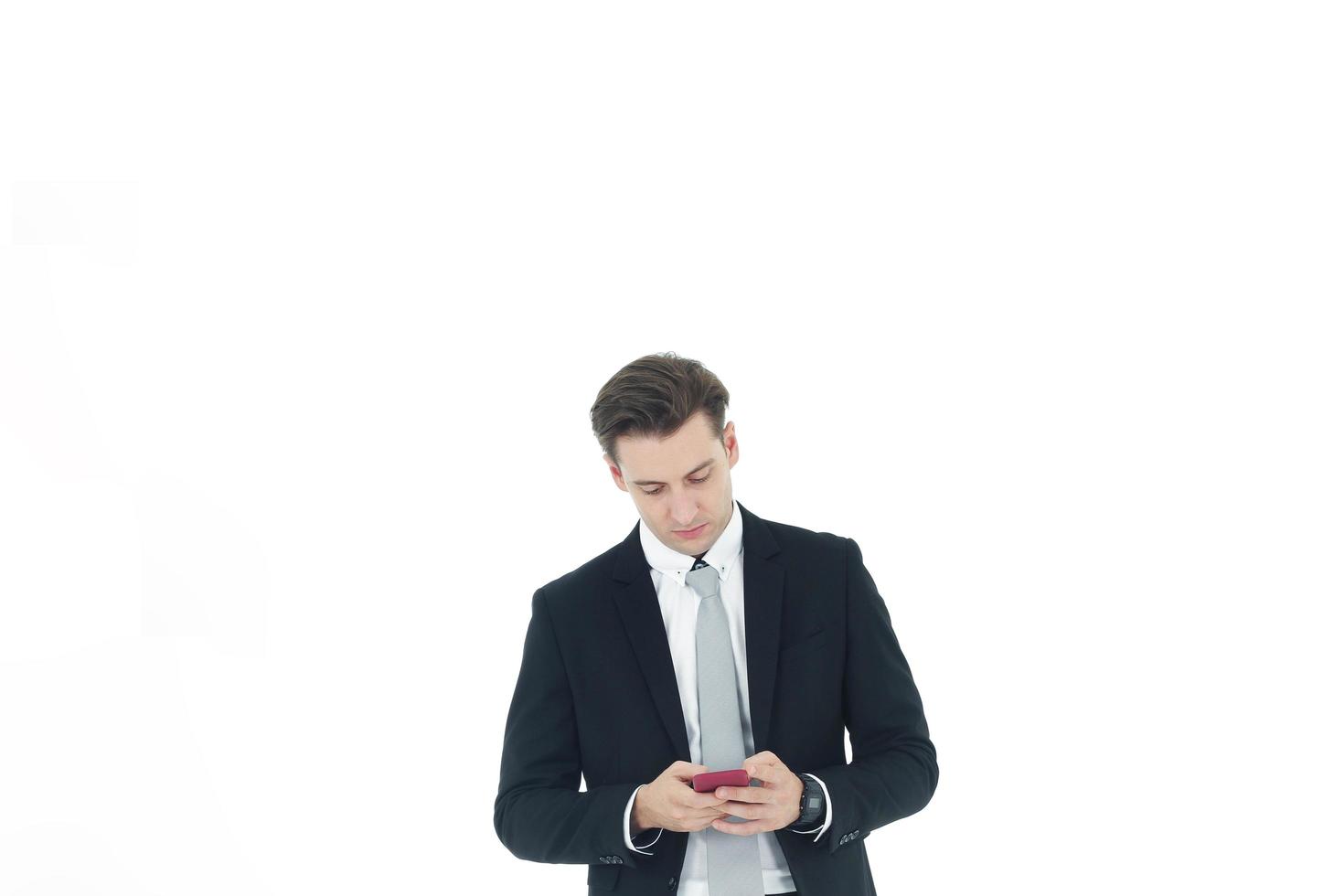 Handsome businessman in a suit hand holding smartphone isolated on white background.Copy Space photo
