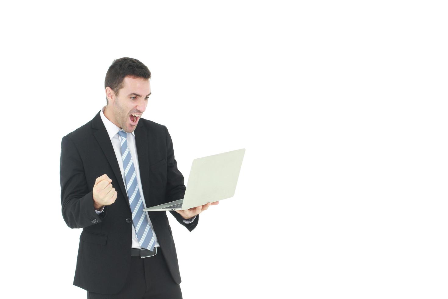 Handsome and smart businessman in black suit isolated hand holding laptop an pretending to be happy in work on white background. Business and Finance concept. Copy Space photo