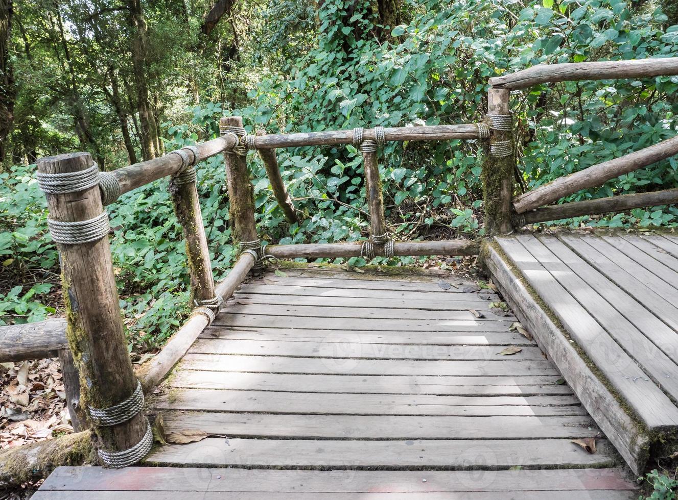 Wooden staircase with the log rail. photo