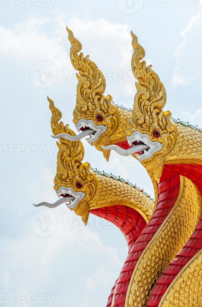 Golden serpent sculpture in the traditional Thai style. photo