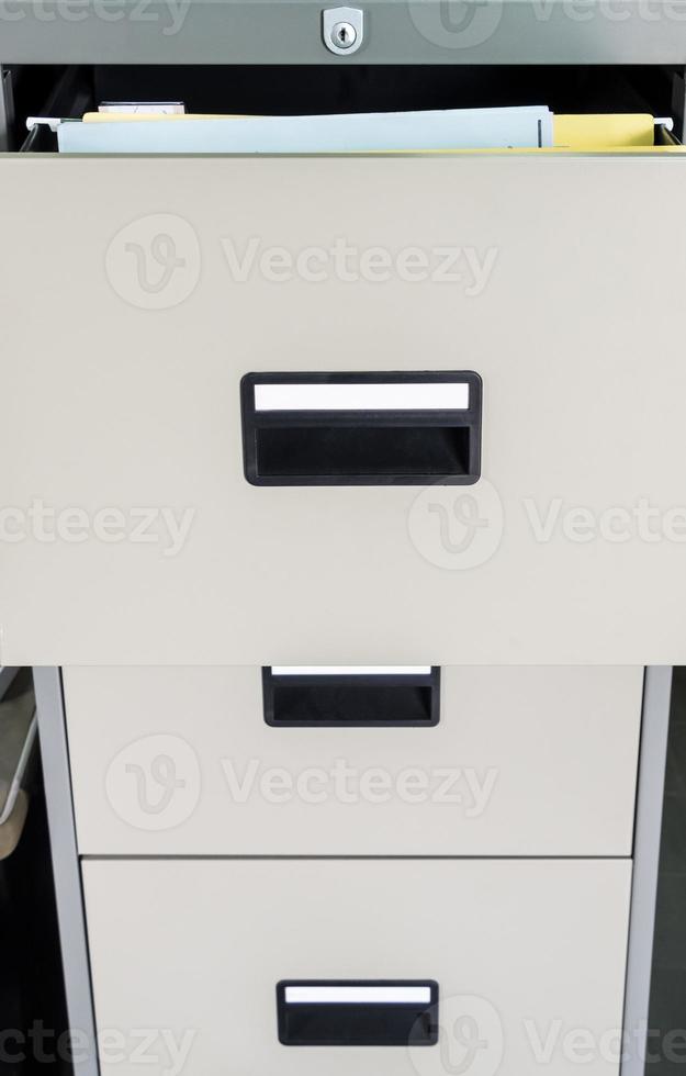 Metal file cabinet with open drawer. photo