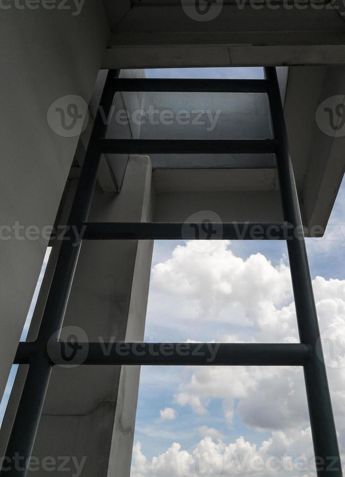 The metal ladder near the outside of the meeting room for climbing to the rooftop. photo