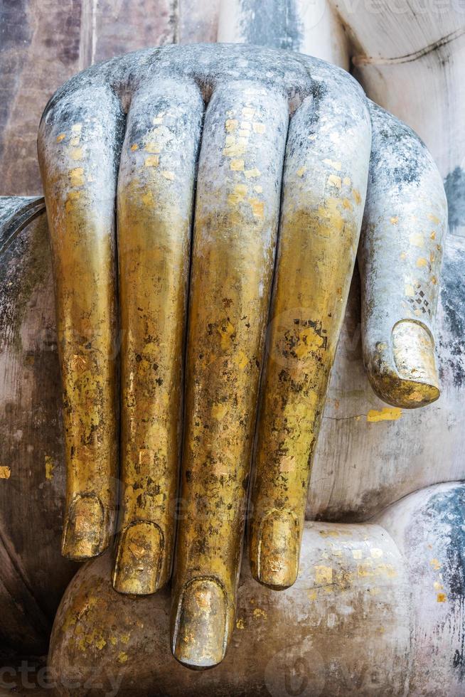 Large hand of the old Buddha statue photo
