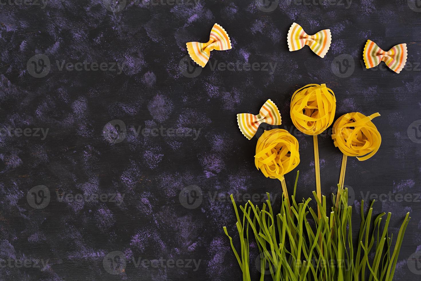 Dry pasta background. Different pasta on dark background. Flat lay. Top view. photo