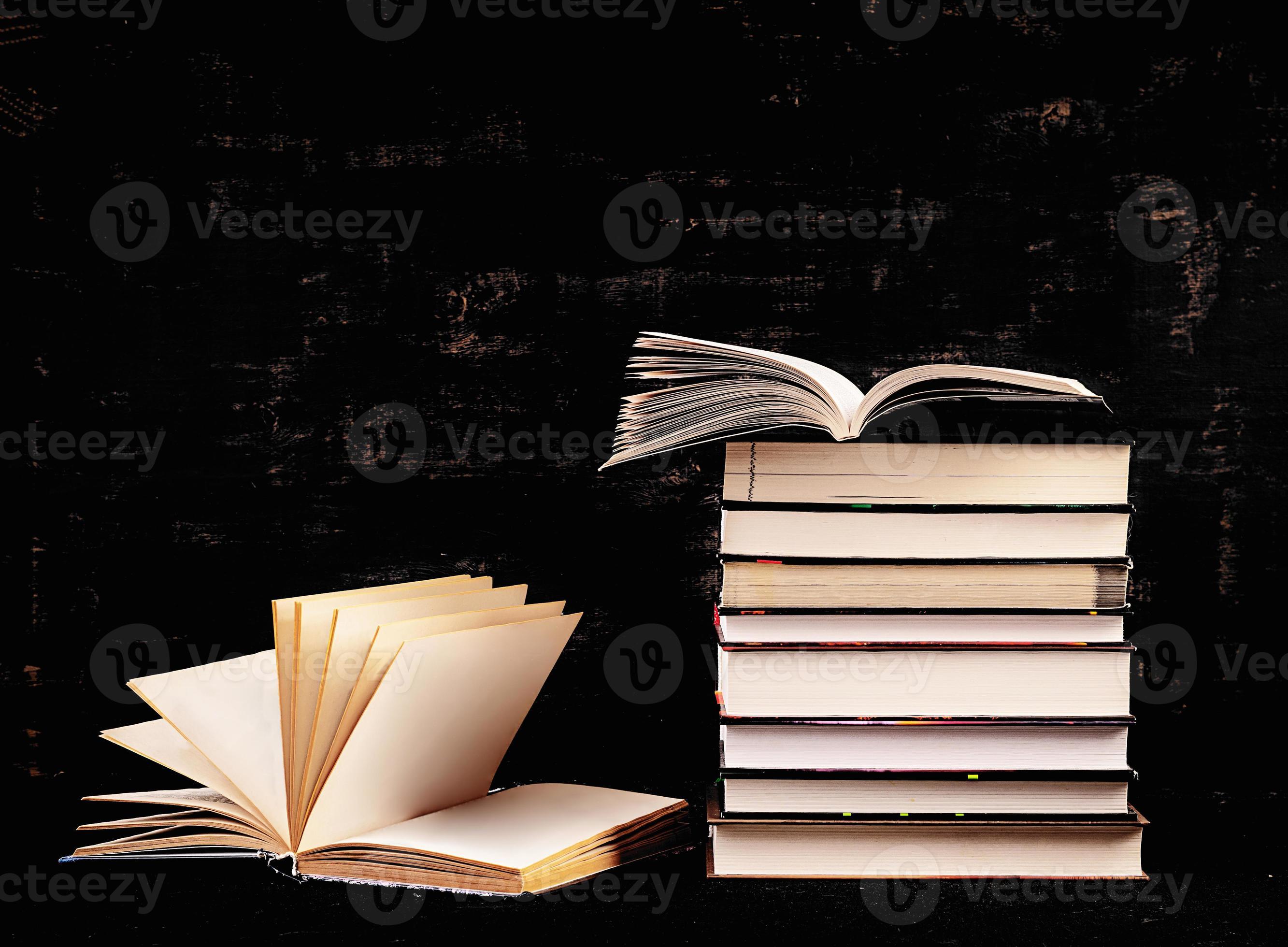 Stack of different books on dark background. Knowledge concept. 7953026