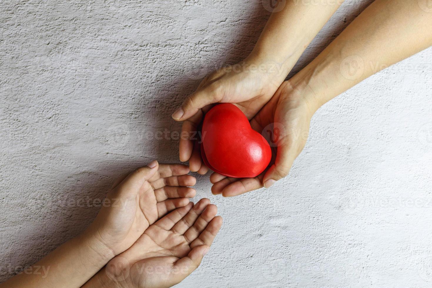 Heart in hand giving heart donation concept. photo