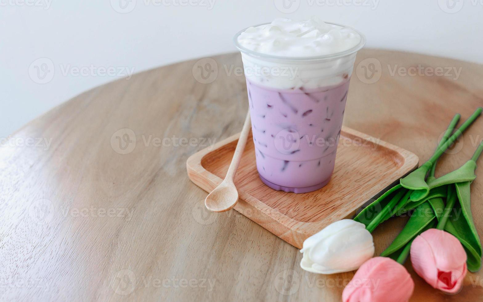 Iced taro tea with milk in a plastic cup photo