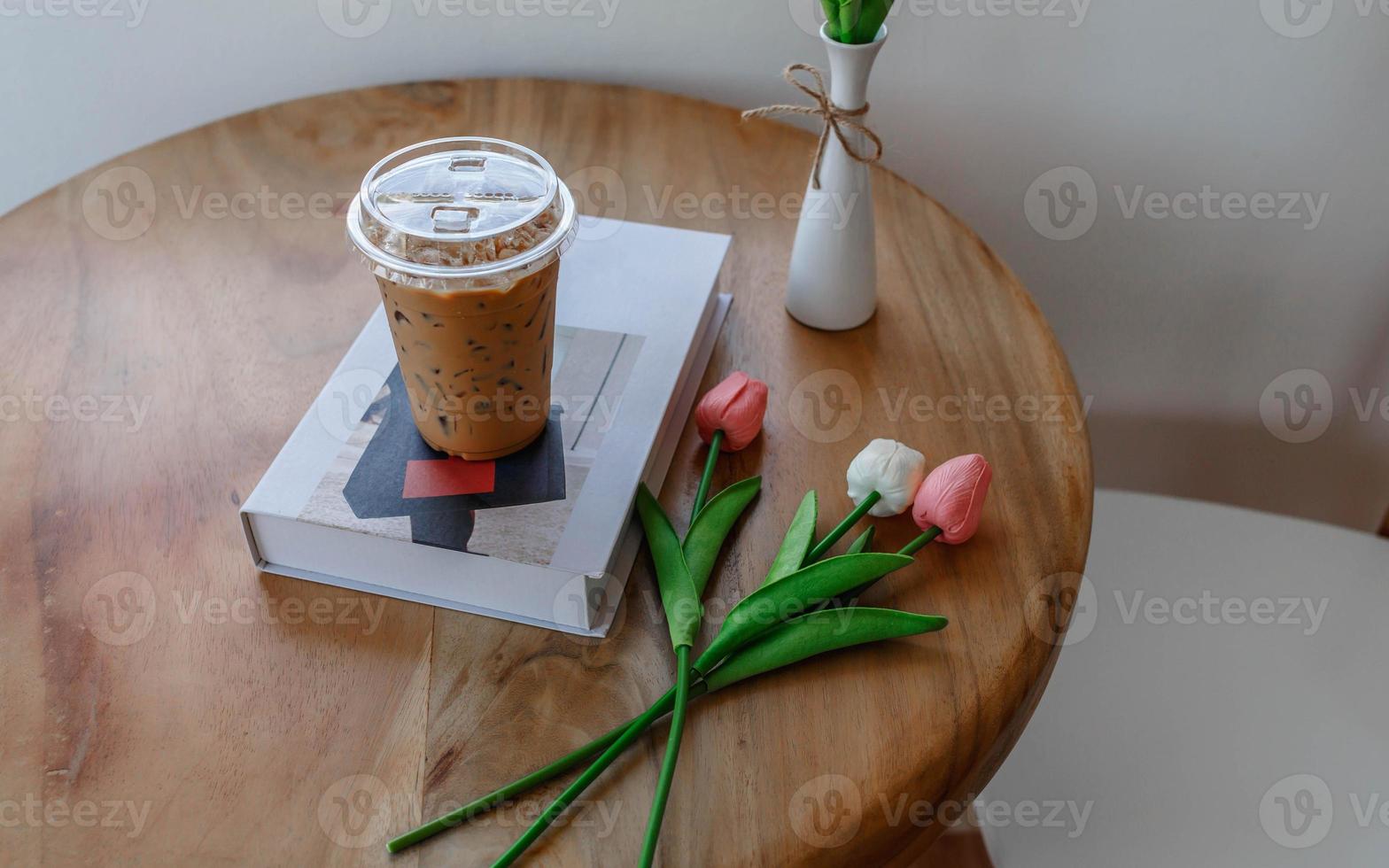Plastic cup of cold espresso coffee on a coffee shop table photo