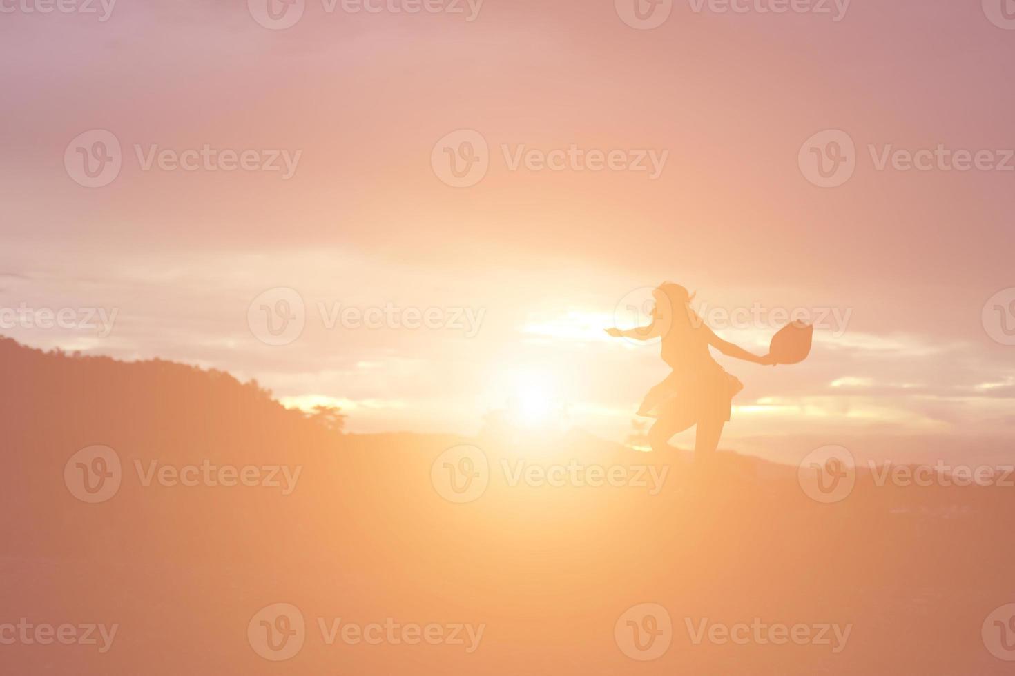 Silhouette of woman praying over beautiful sky background photo