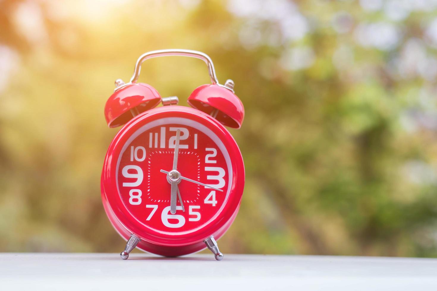 6 o'clock Clock Vintage on Wood Table with Sun Light photo