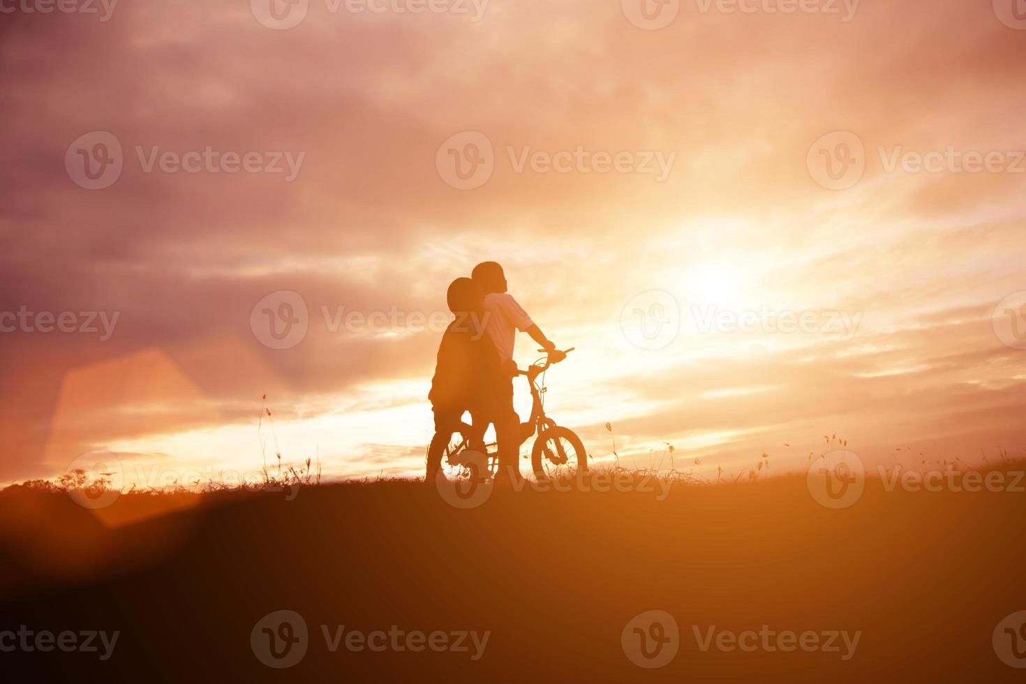 two little boys bike silhouette photo