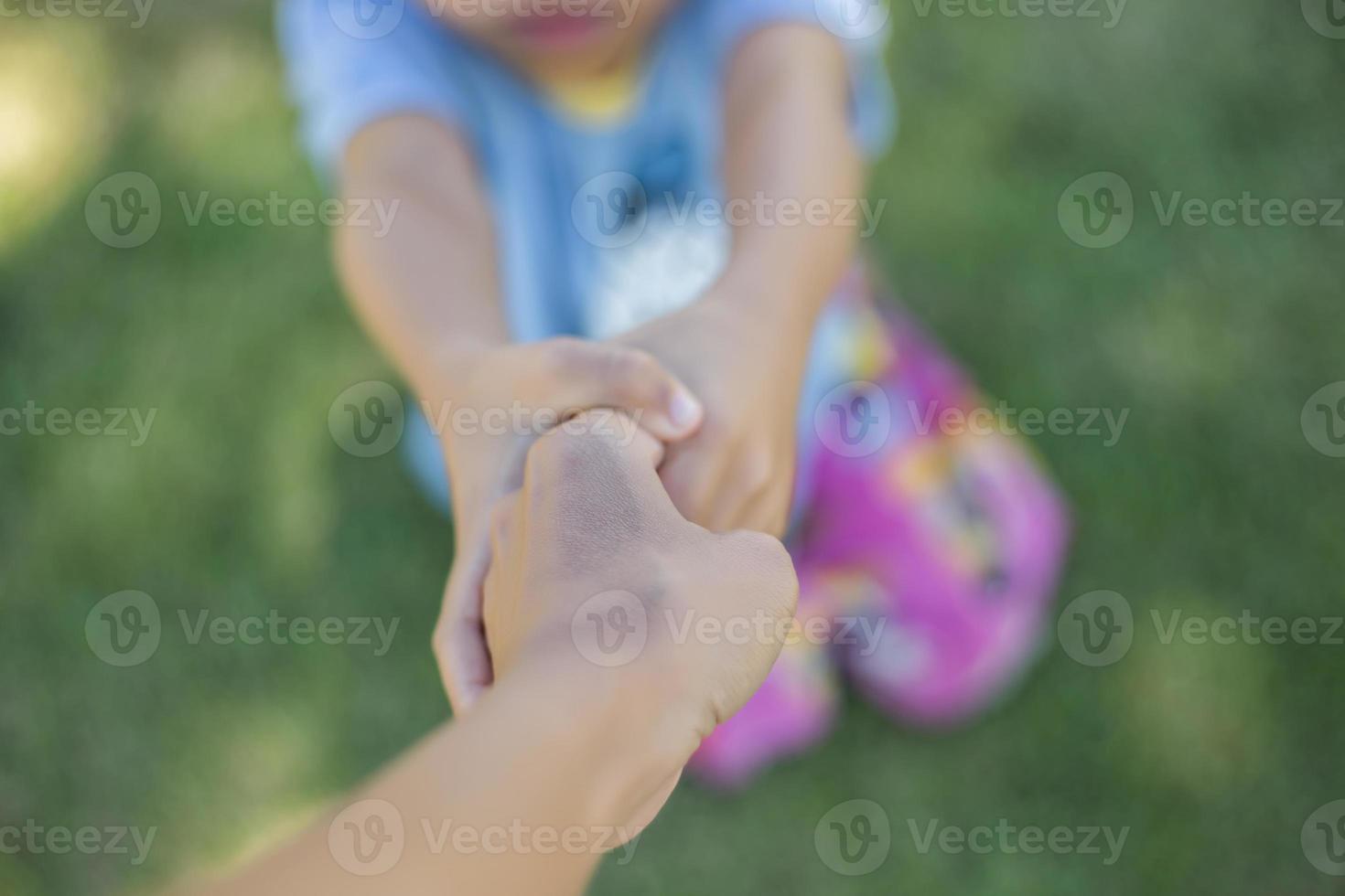 Happy boy child is smiling enjoying adopted life. Portrait of young boy in nature, park or outdoors. Concept of happy family or successful adoption or parenting. photo