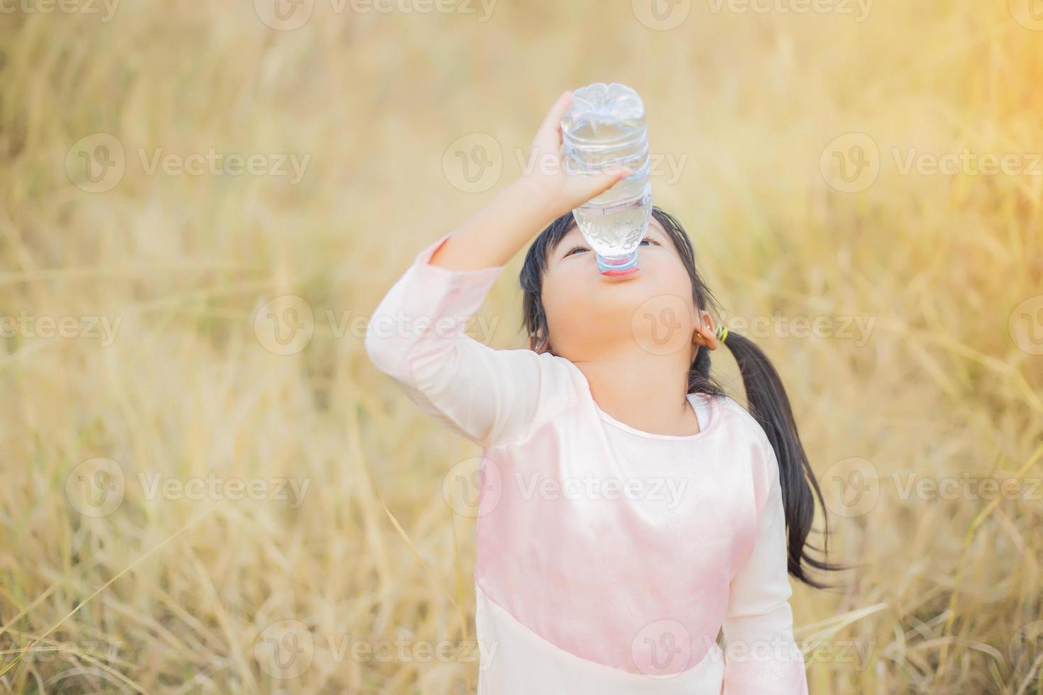 Little girl drinking water. photo
