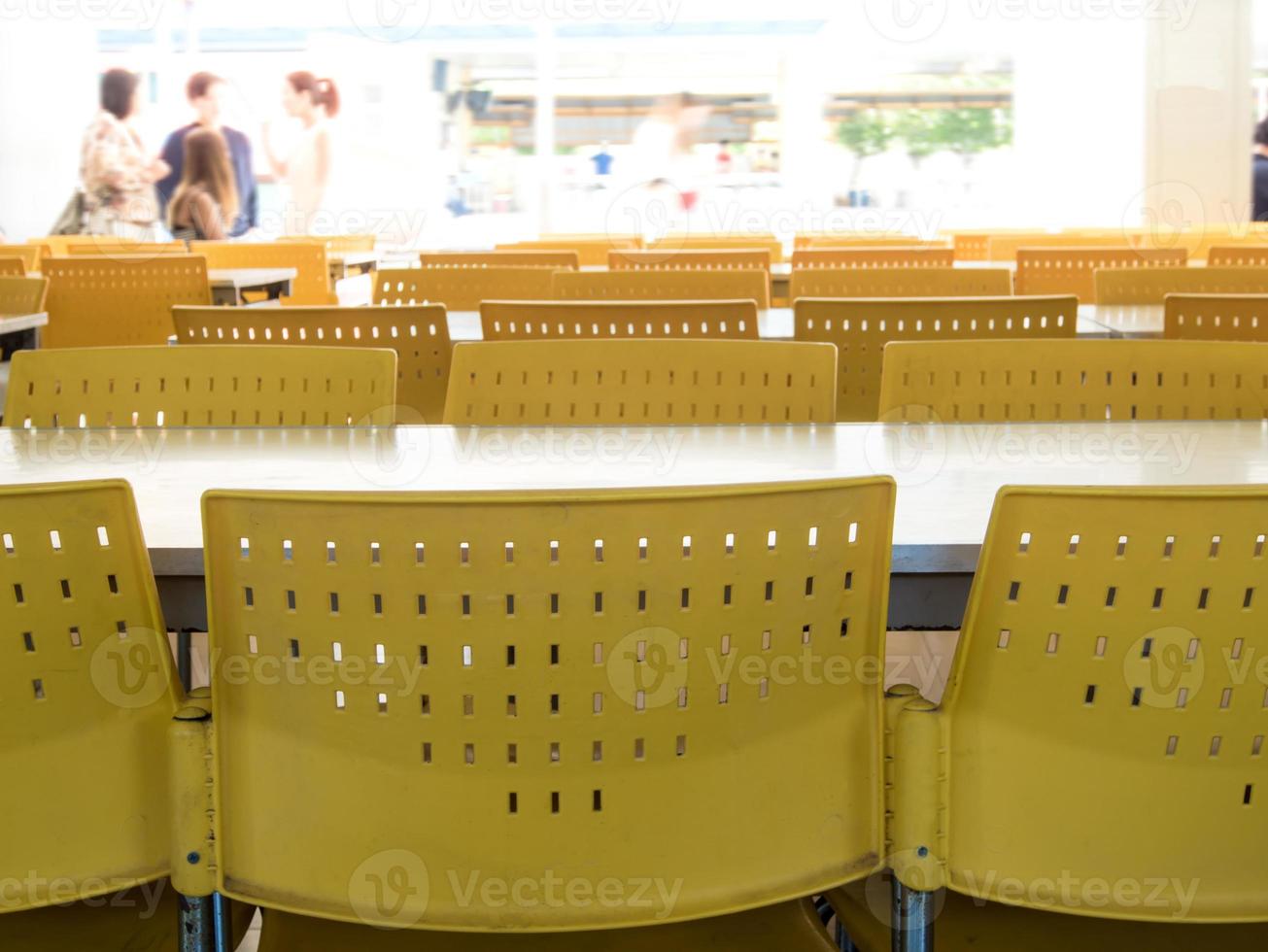 Empty tables and chairs that nobody sit in the cafeteria photo