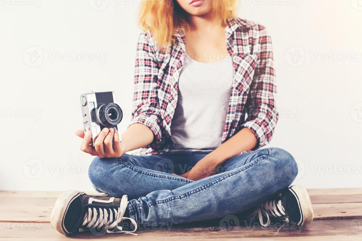 Young beautiful hipster woman with an old retro camera. photo