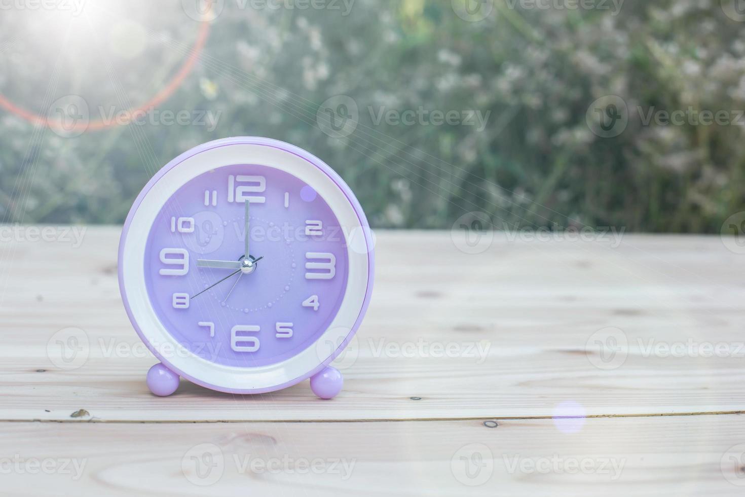 alarm clock with abstract nature bokeh blur background. photo