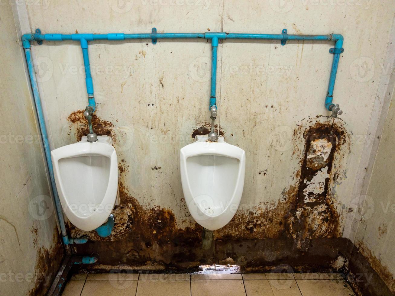 The dirty urinal row of the temporary toilet in the railway station. photo