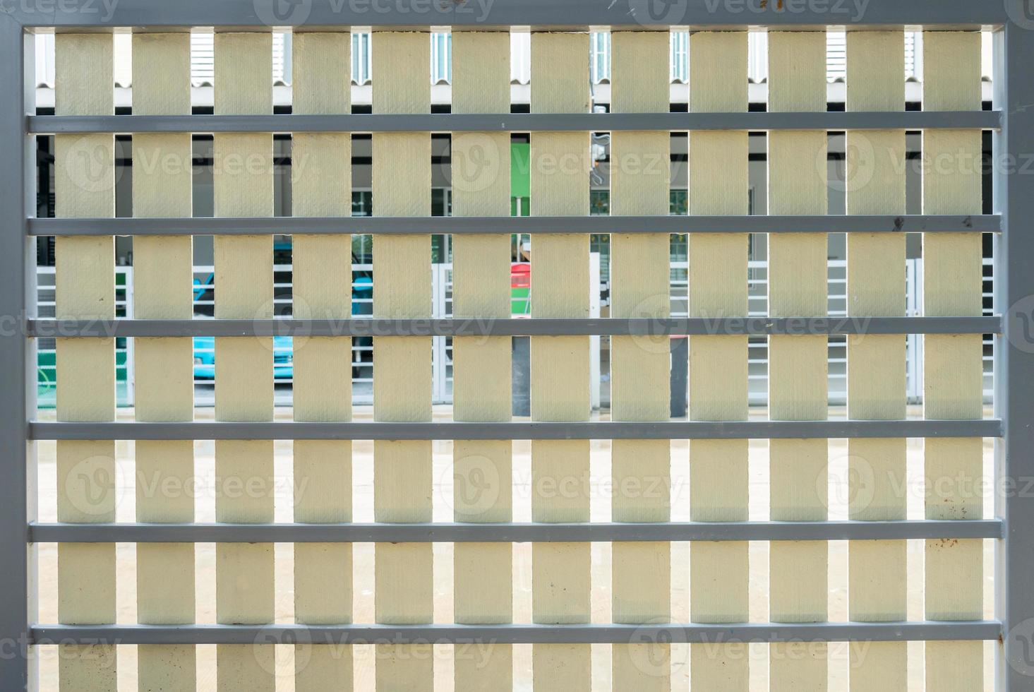Artificial wooden fence on the metal frame photo