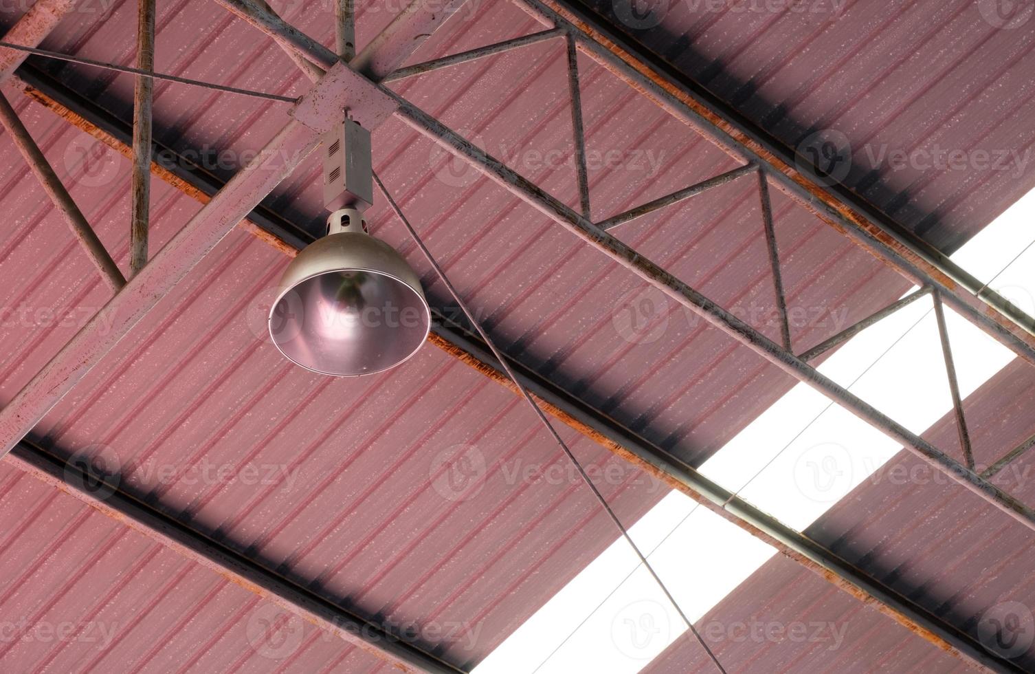 The metal housing of the downlight LED which is without the LED bulb is hanging on the concrete beam. photo