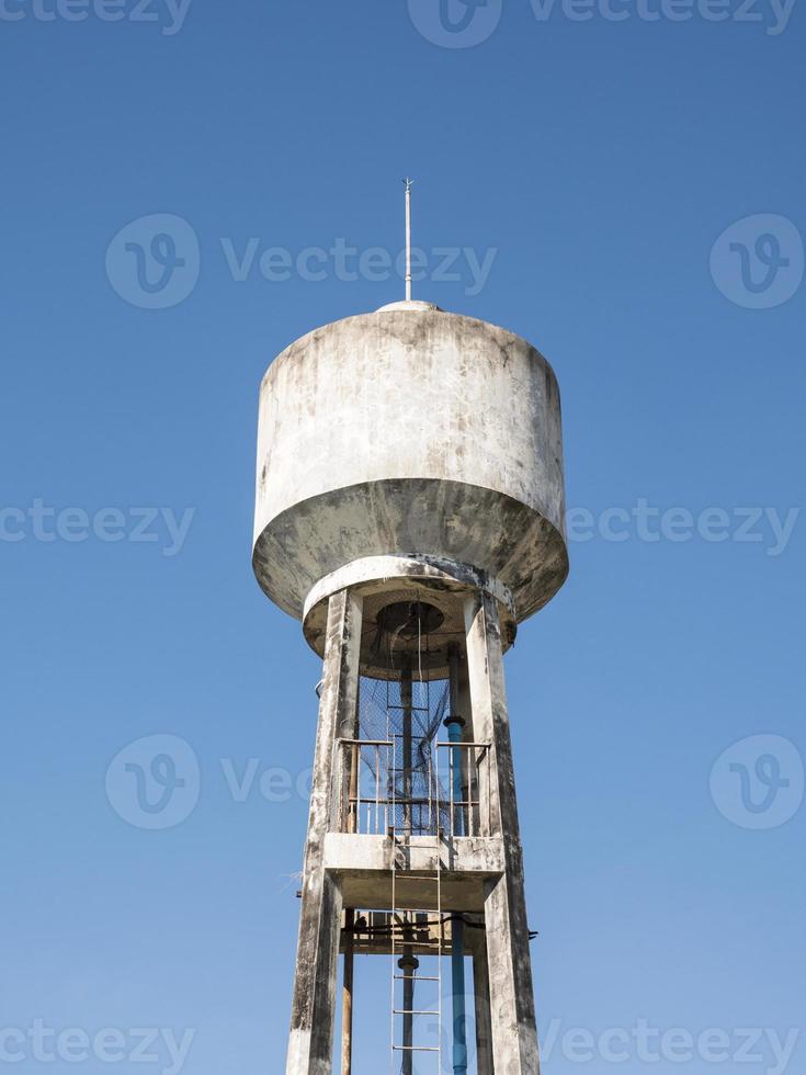 Concrete water tower with the metal ladder. photo