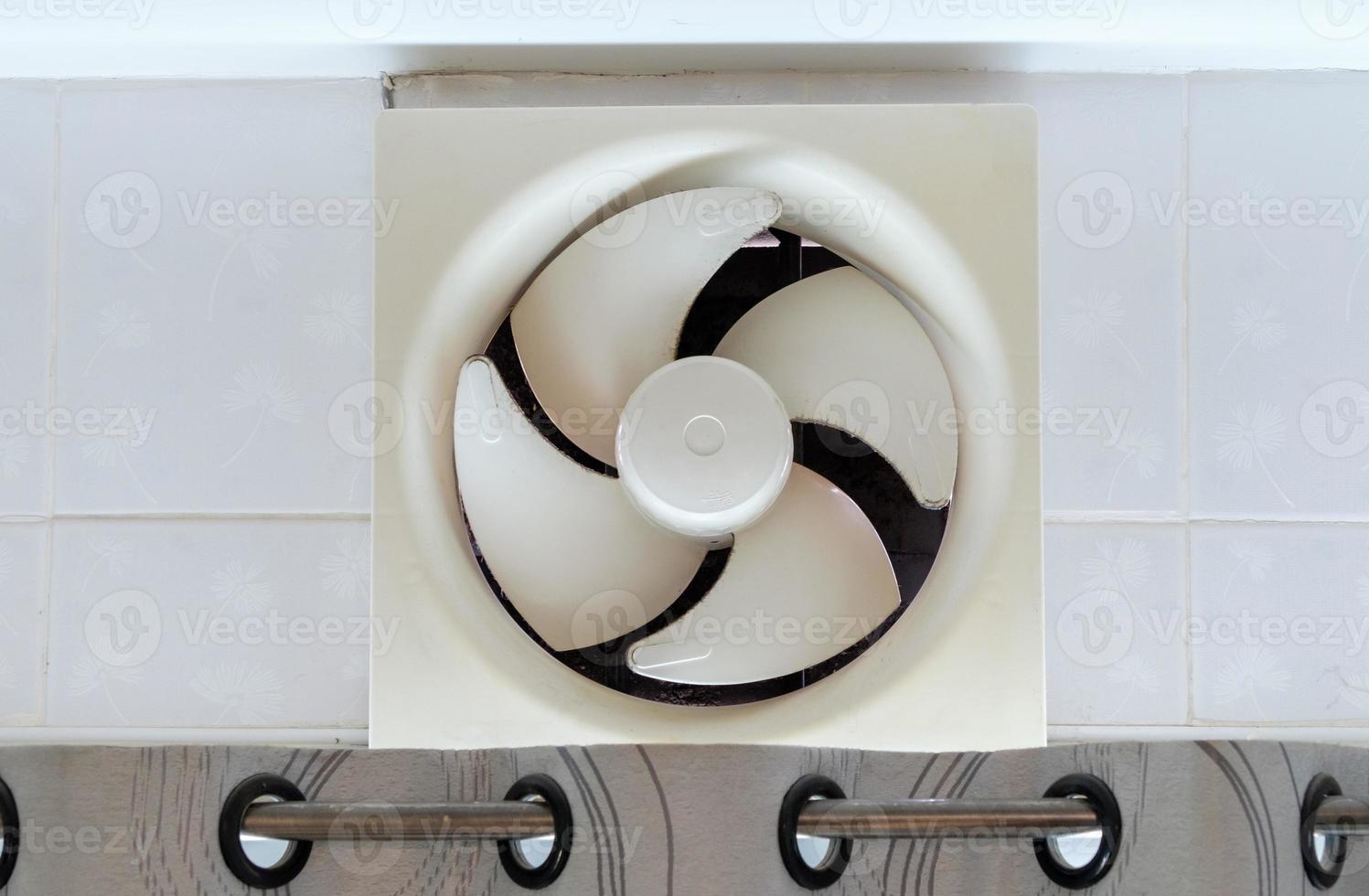The dirty ventilation fan over the kitchen door in the urban house. photo