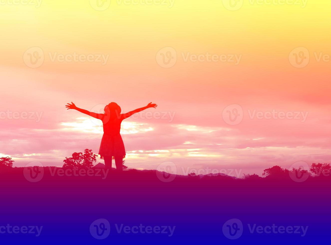 Silhouette of woman praying over beautiful sky background photo