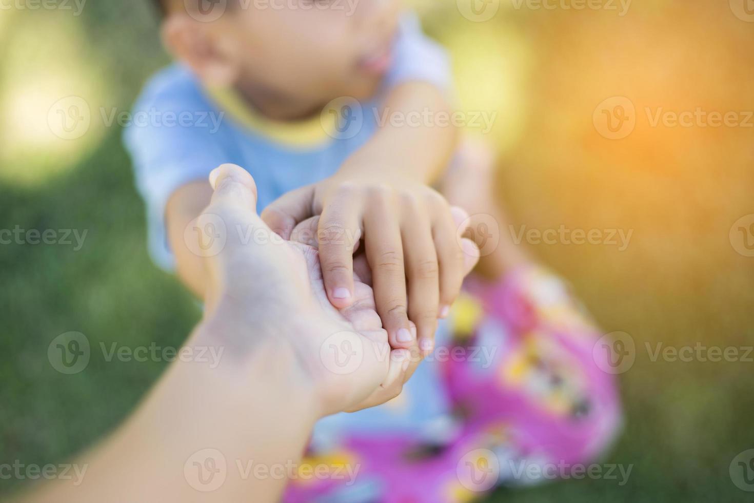 Happy boy child is smiling enjoying adopted life. Portrait of young boy in nature, park or outdoors. Concept of happy family or successful adoption or parenting. photo