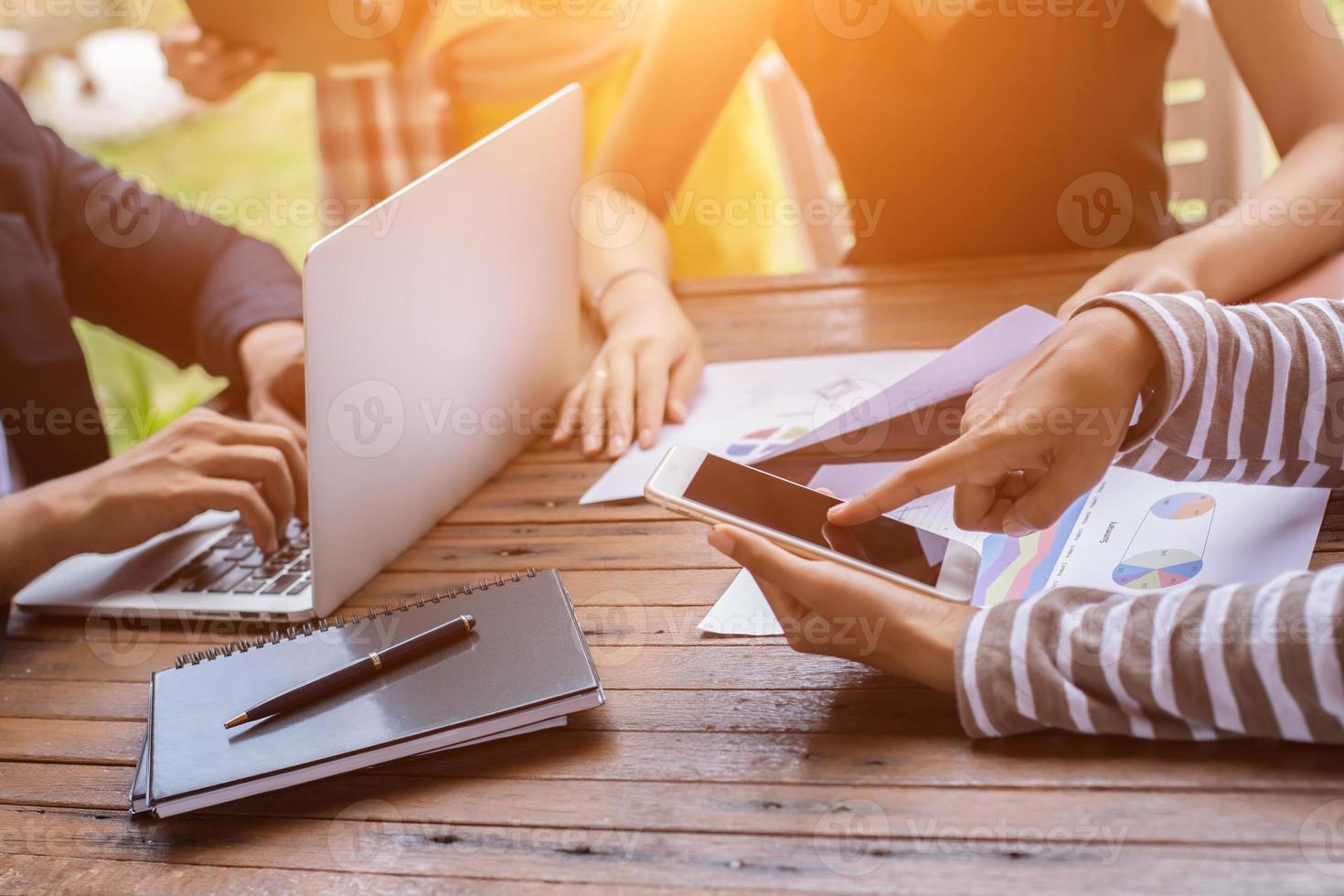 Business team working on laptop, while sitting at office. Business people. photo