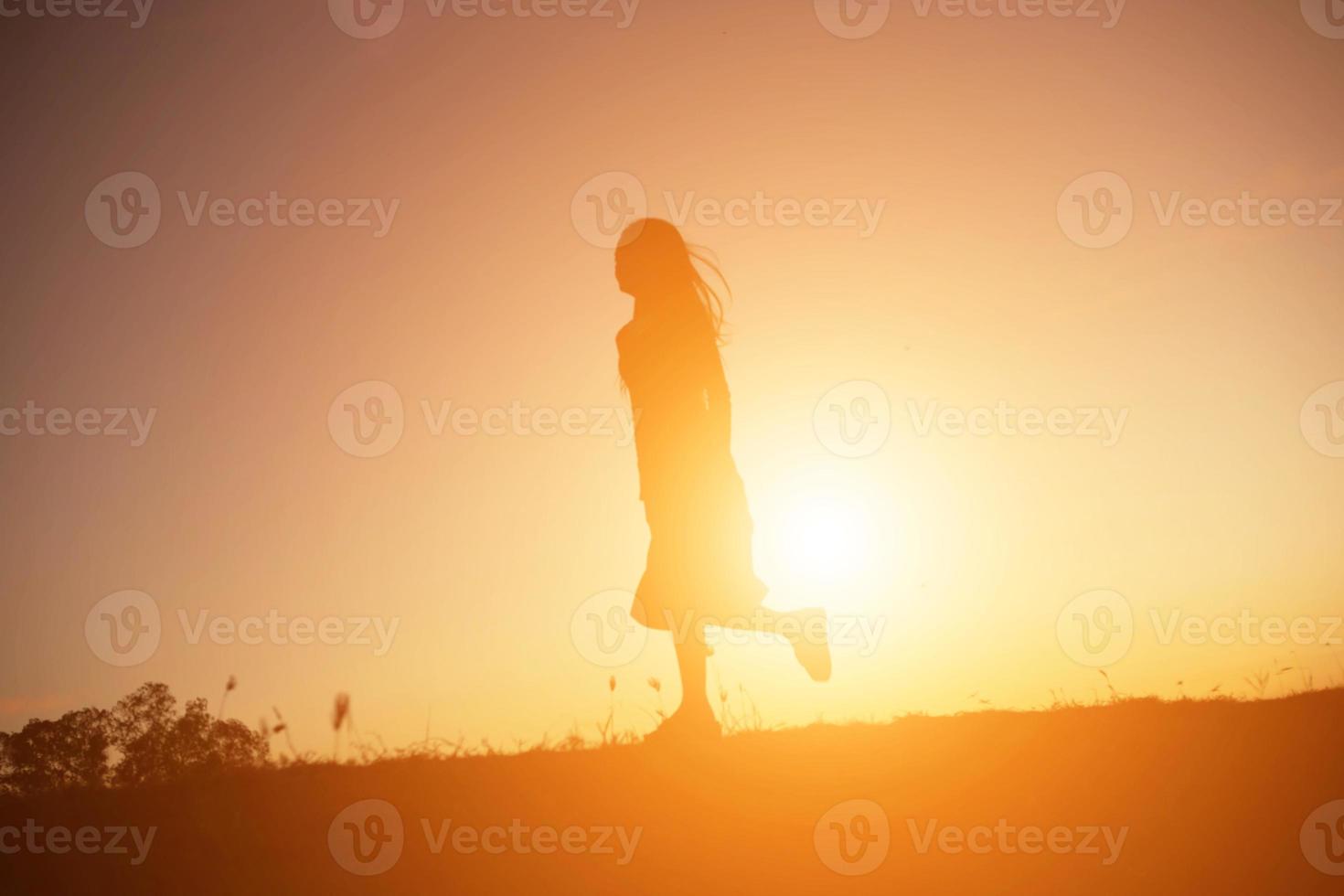 silhouette of a young woman standing alone photo