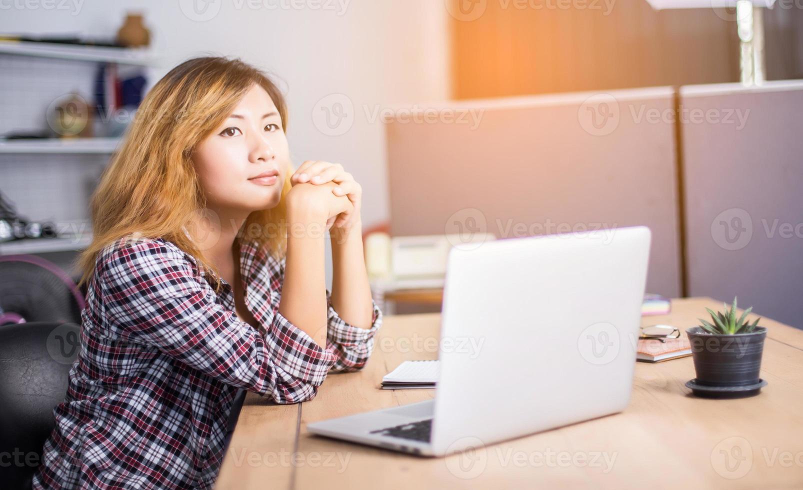 business woman writing something on notepad in office. photo