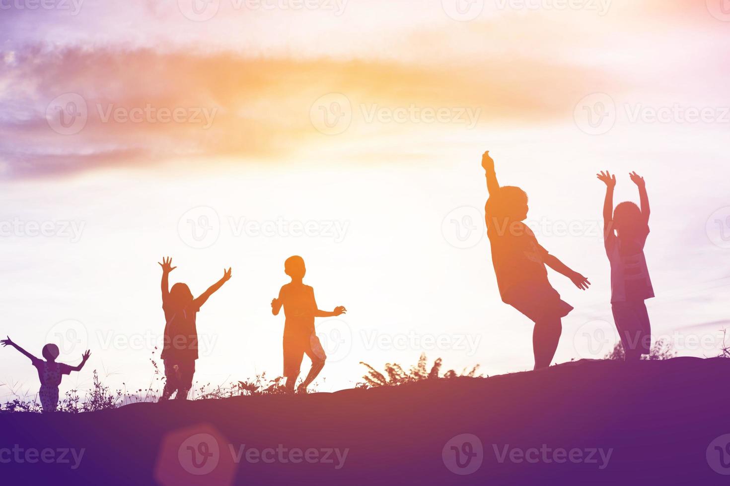 silhouette of a happy children and happy time sunset photo