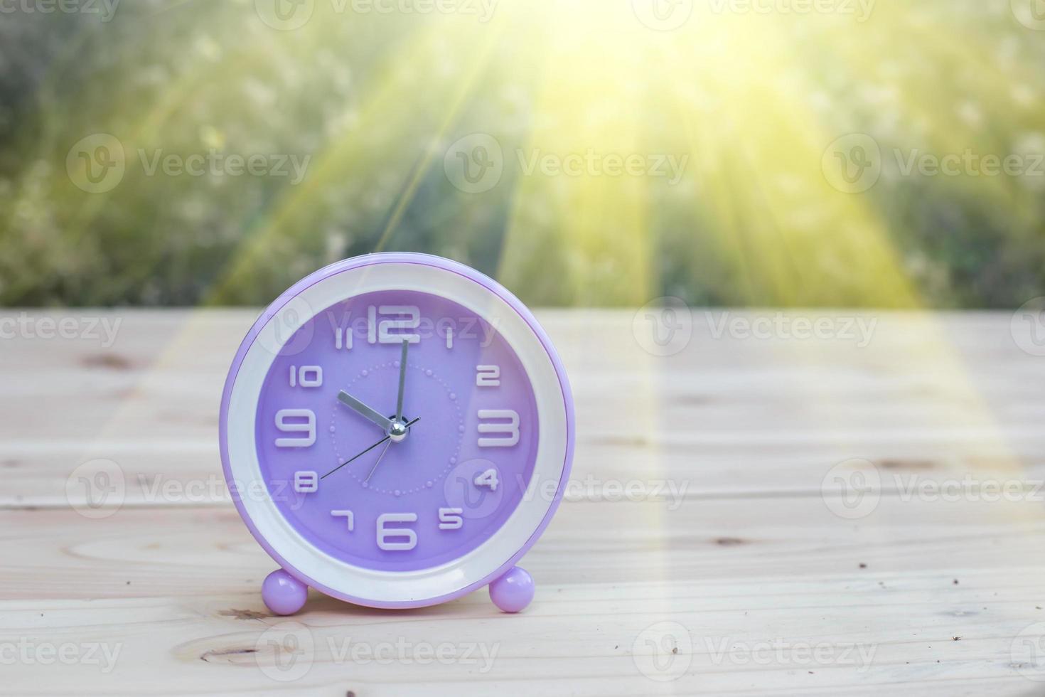 alarm clock with abstract nature bokeh blur background. photo