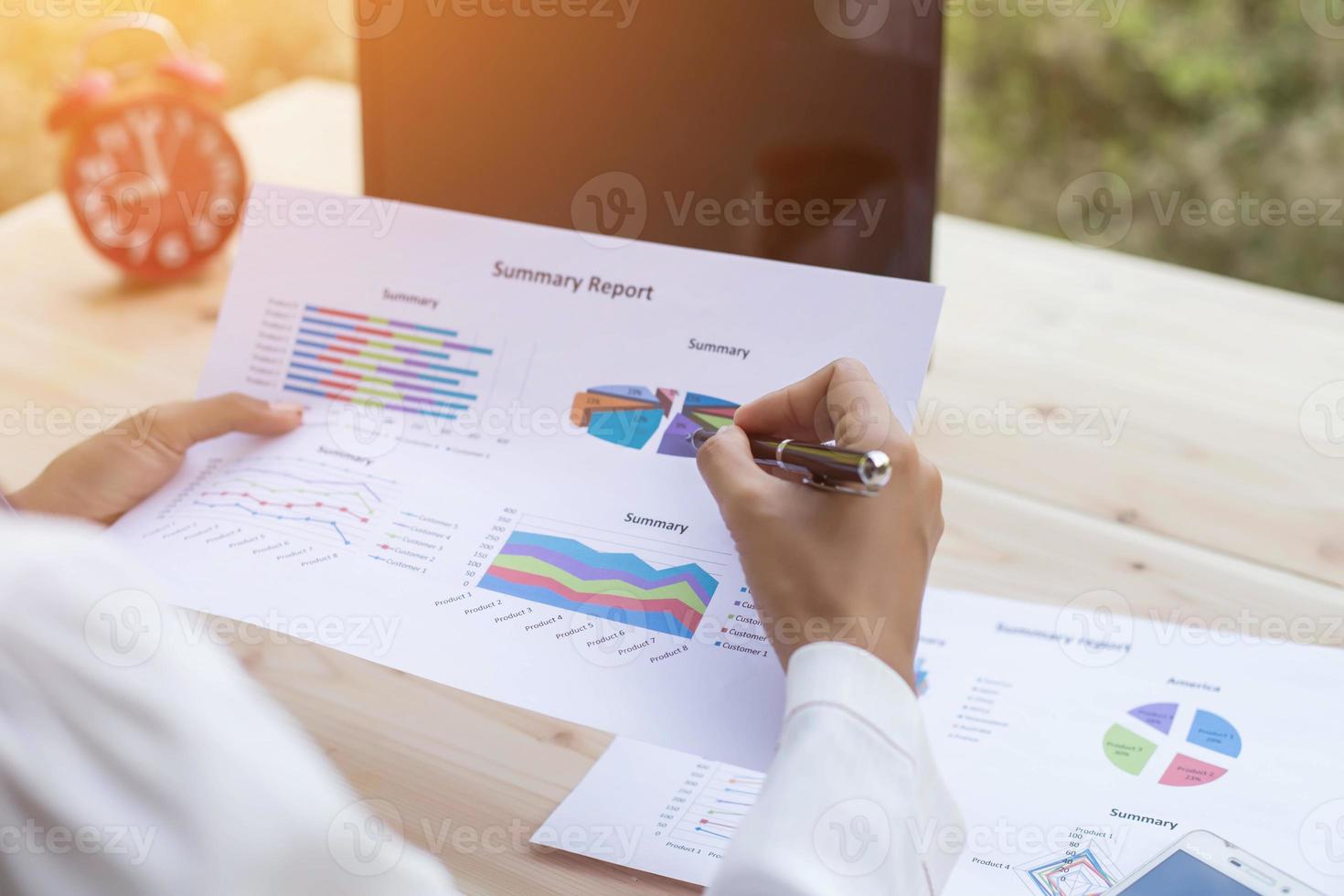 Hands of Businessman working on Laptop Computer with Data Charts photo