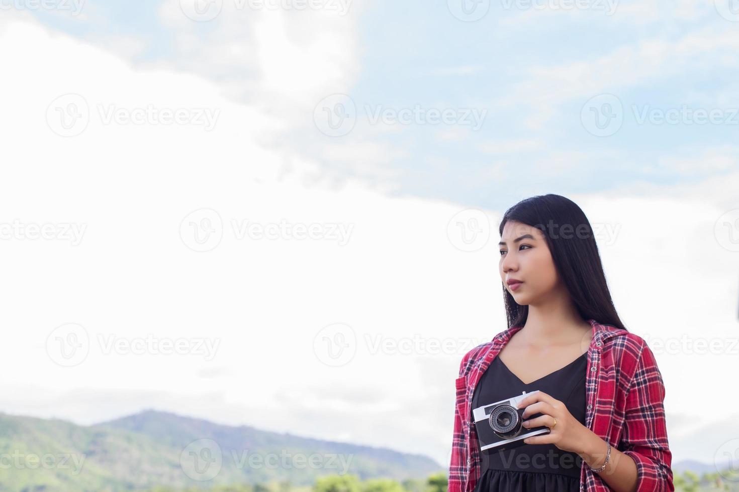 Vintage of beautiful women photography standing hand holding retro camera with sunrise,dream soft style photo