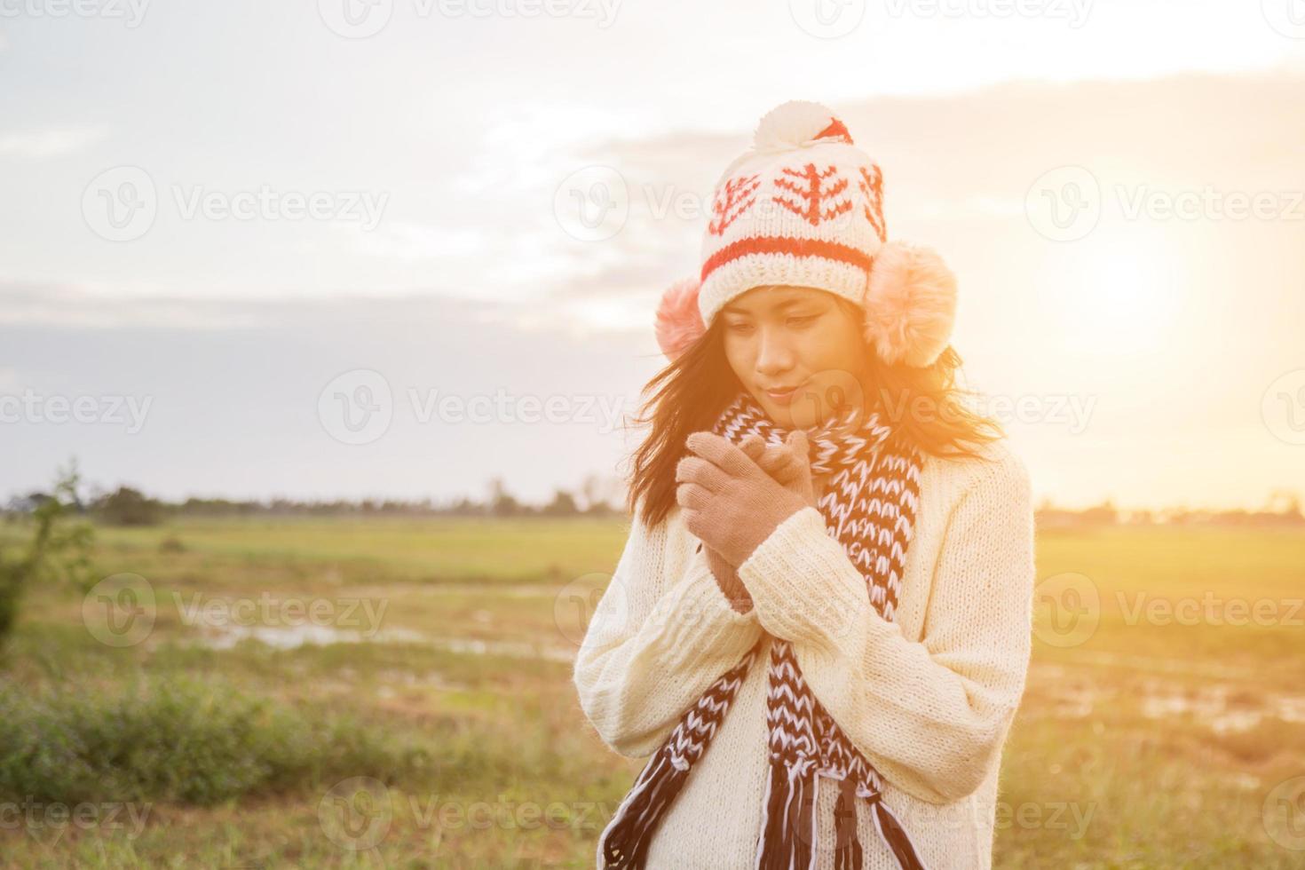 Young woman was playing in a field of flowers in the winter air. photo